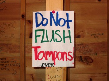 Do I Have To Hang A “Do Not Flush Tampons” Sign In My Bathroom?